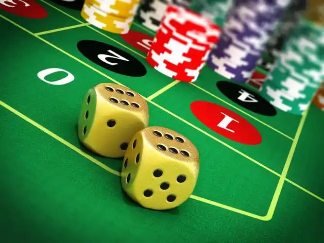 Baccarat table dealer displaying Player and Banker cards